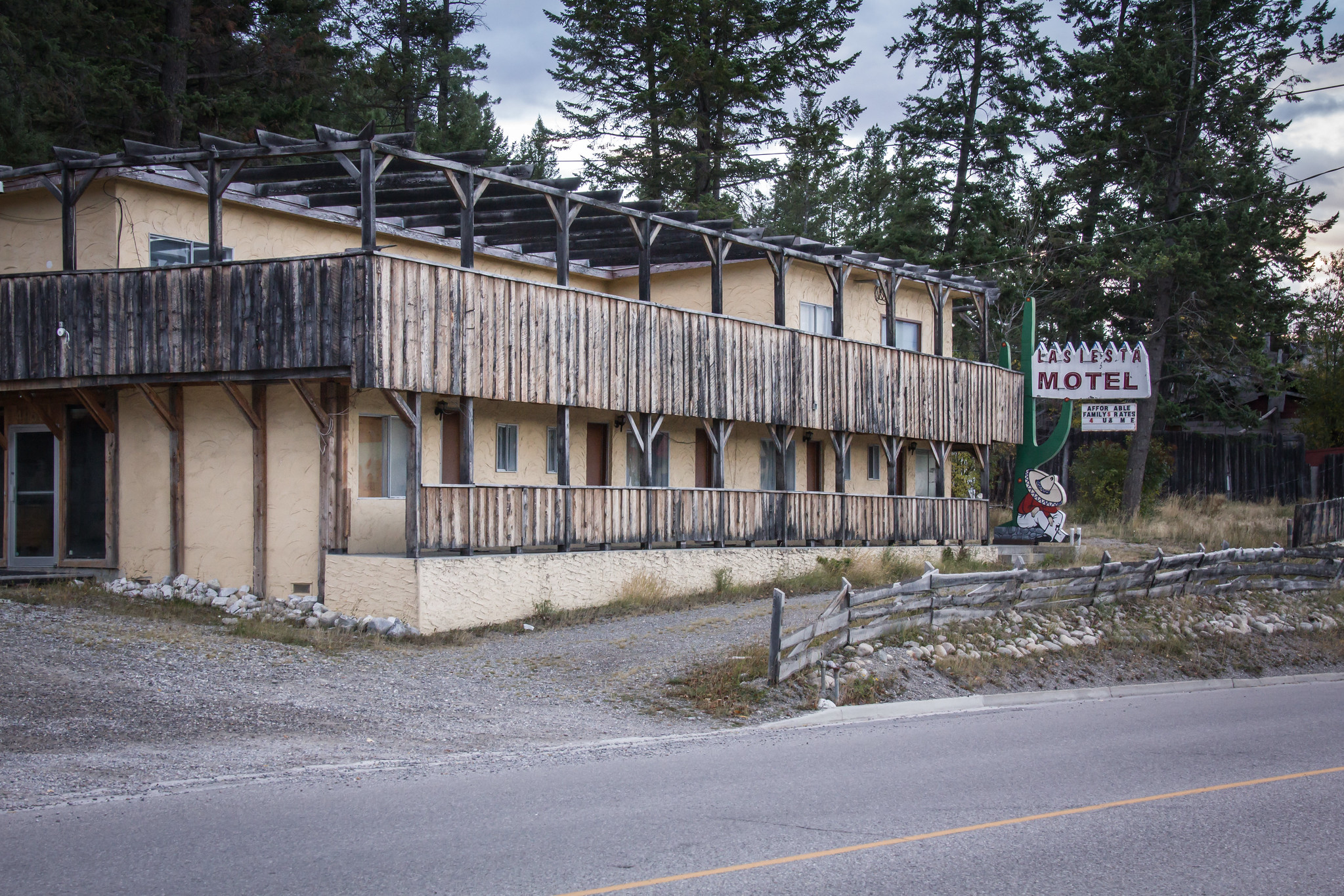 The abandoned La Siesta Motel. A sign features a man wearing a sombrero, leaning against a cactus.