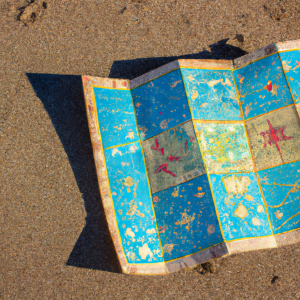 a colourful old-fashioned treasure map lying on a beach