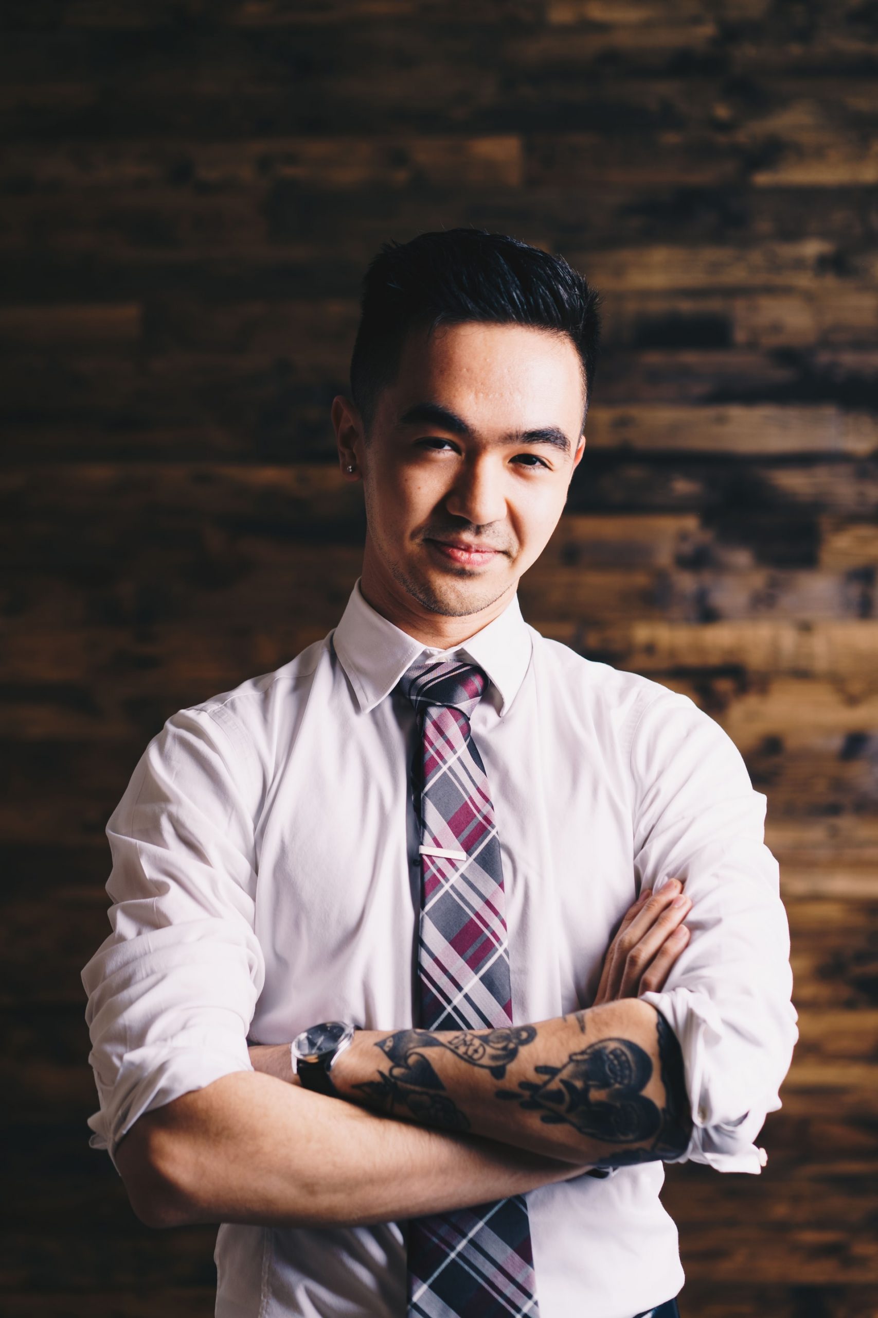 Image of a business person with tattoos and piercings