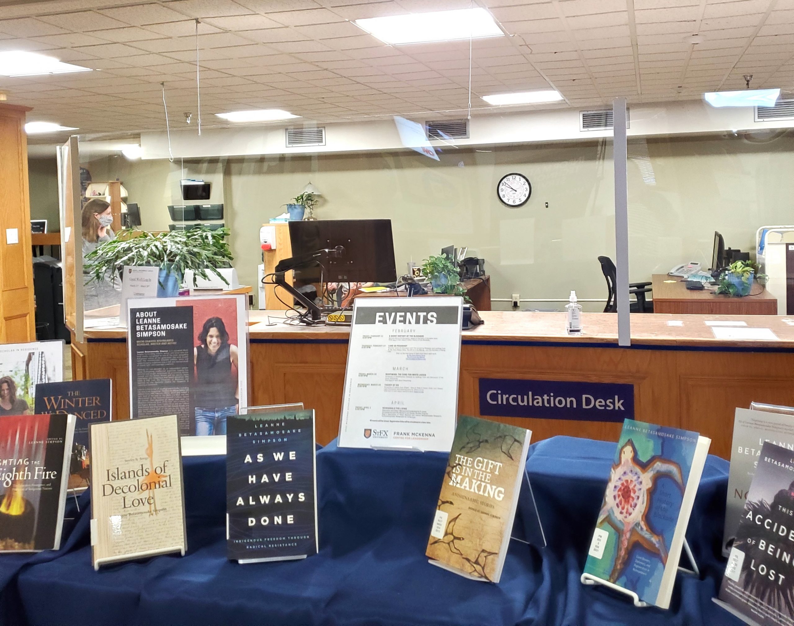 Photograph of the Angus L. Macdonald Library Access Services Desk (background) with a book display in the foreground