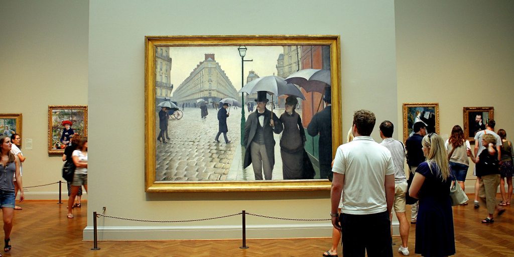 People viewing "Paris Street; Rainy Day, 1877" by Gustave Caillebotte