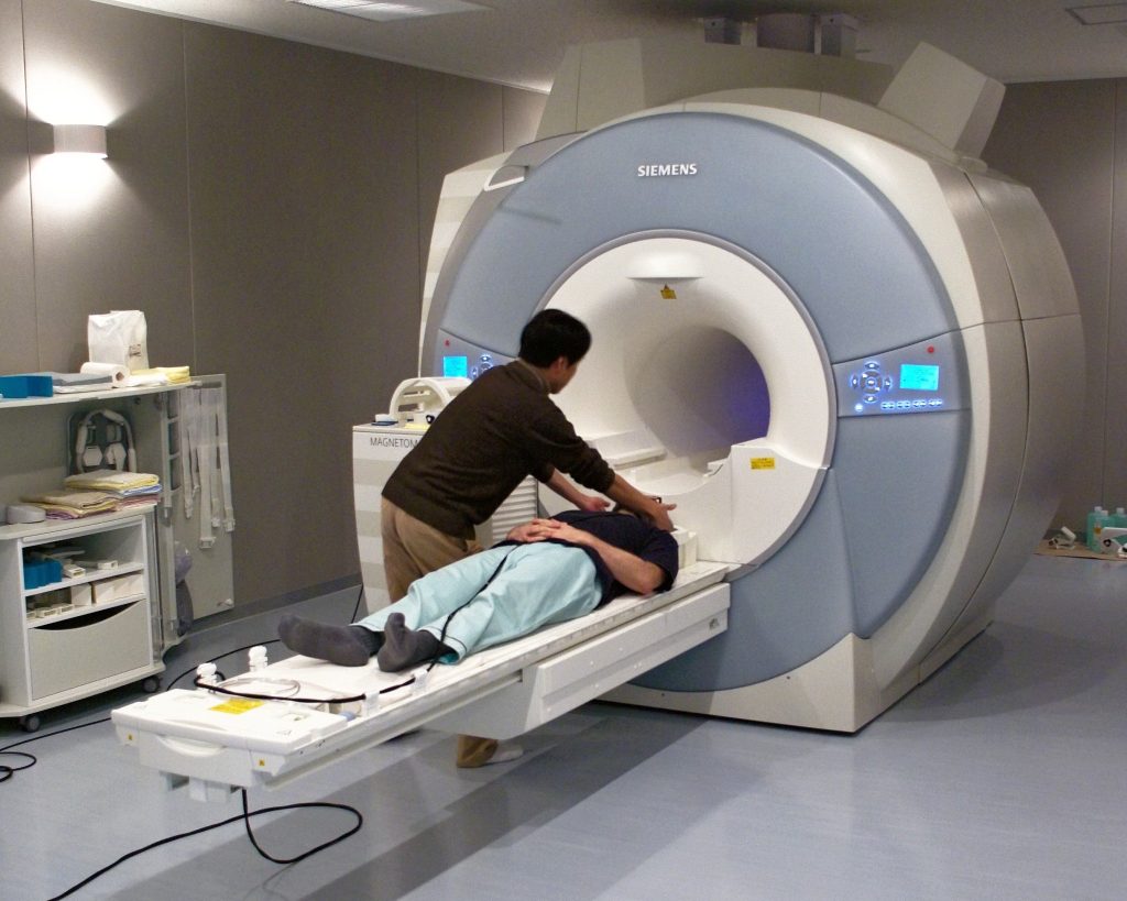 A technologist positions a participant in an MRI.